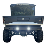 Back view of a blue truck with visible branding on a white background