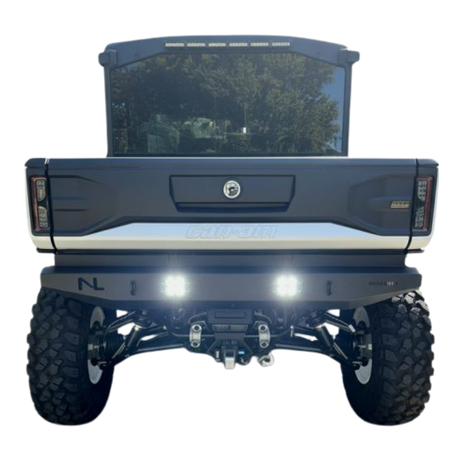 Back view of a blue truck with visible branding on a white background