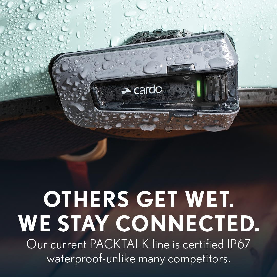 Cardo Packtalk device on a car dashboard with water droplets, emphasizing waterproof certification.